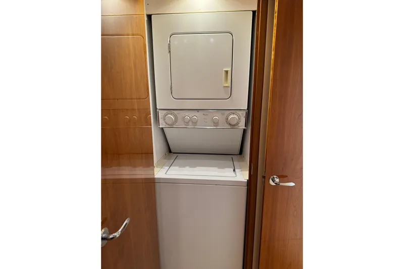 Glomar I Yacht Photos Pics Stacked washer and dryer in 2004 Hatteras 60 Convertible yacht interior.