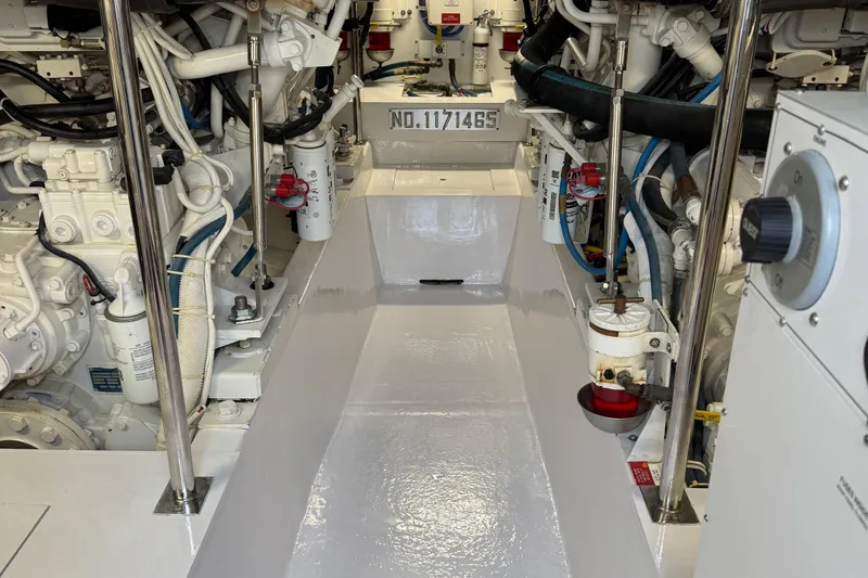 Glomar I Yacht Photos Pics Engine room of 2004 Hatteras 60 Convertible yacht, showcasing mechanical components and systems.