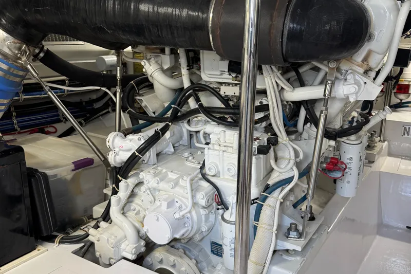 Glomar I Yacht Photos Pics Engine room of a 2004 Hatteras 60 Convertible yacht, showcasing mechanical components.