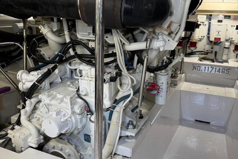 Glomar I Yacht Photos Pics Engine room of a 2004 Hatteras 60 Convertible yacht, showcasing mechanical components.