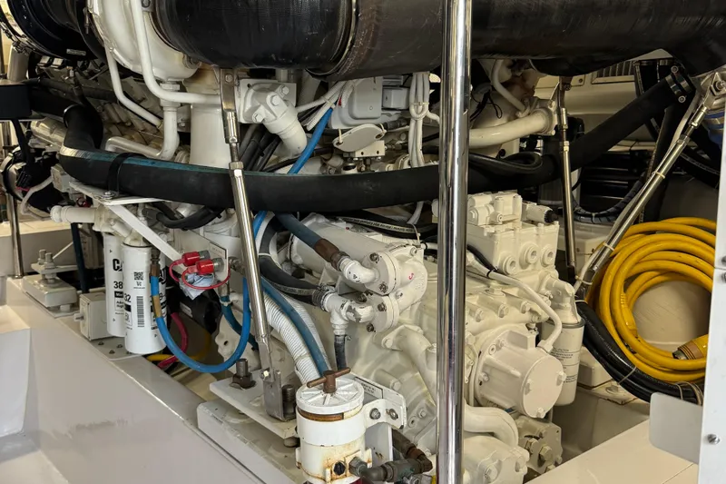 Glomar I Yacht Photos Pics Engine room of 2004 Hatteras 60 Convertible yacht, showcasing complex machinery and components.