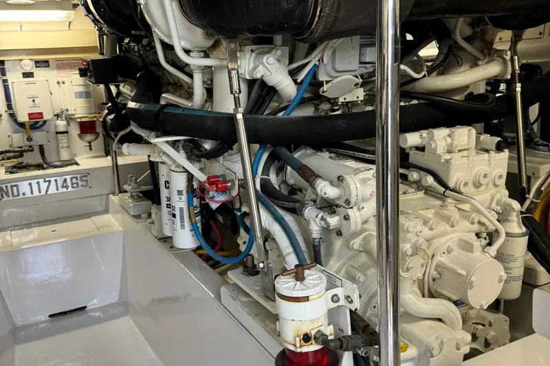 Glomar I Yacht Photos Pics Engine room of 2004 Hatteras 60 Convertible yacht, showcasing complex machinery and components.