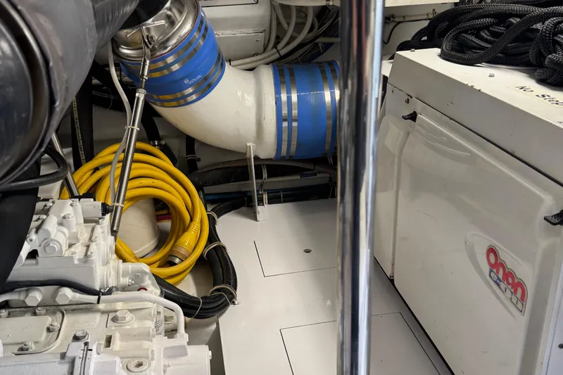 Glomar I Yacht Photos Pics Engine room of 2004 Hatteras 60 Convertible with Onan generator and coiled yellow cables.