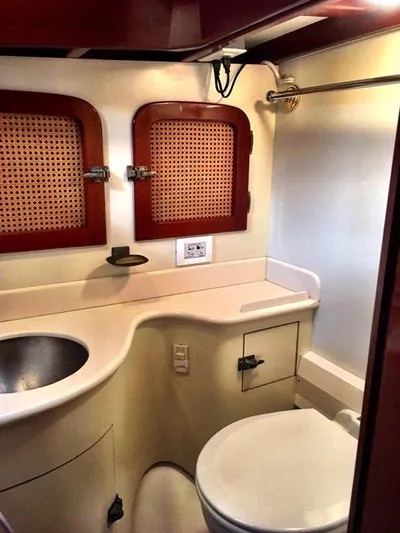 Light Reign Yacht Photos Pics 2000 Cherubini Schooner bathroom with sink, toilet, and wooden accents.
