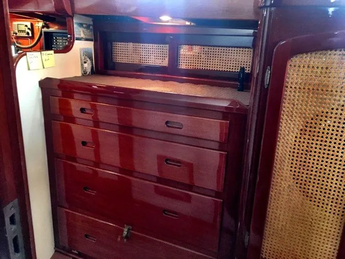 Light Reign Yacht Photos Pics Interior of 2000 Cherubini Schooner with polished wood drawers and woven cabinet accents.