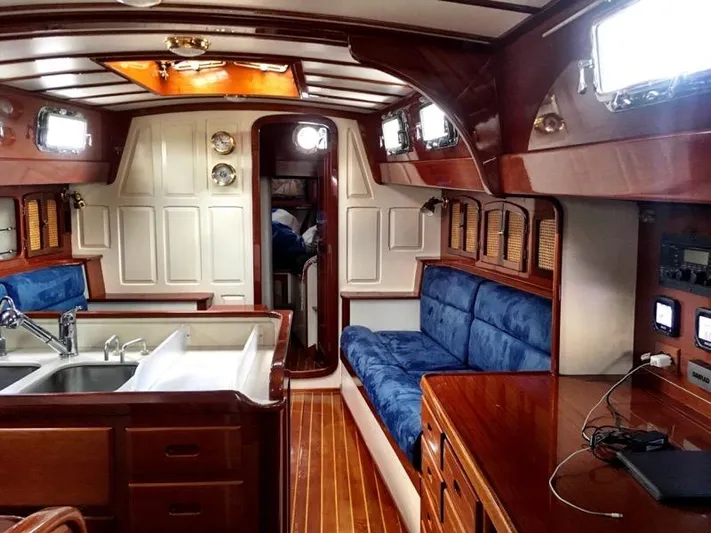 Light Reign Yacht Photos Pics Interior of 2000 Cherubini Schooner with wood finish, blue seating, and modern amenities.
