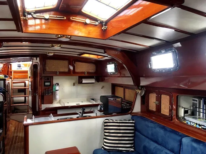 Light Reign Yacht Photos Pics Interior of 2000 Cherubini Schooner with wooden finish and cozy seating area.