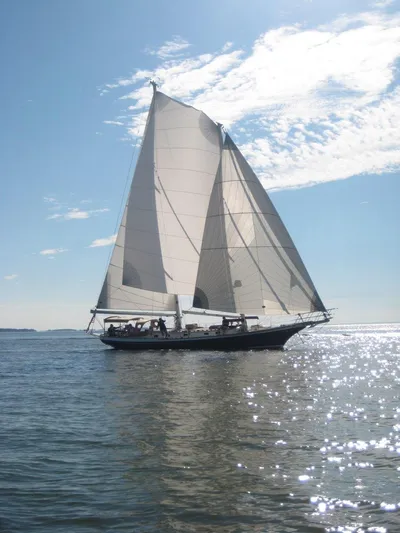 Light Reign Yacht Photos Pics Cherubini Schooner 2000 sailing on a sunny day with clear skies and sparkling water.