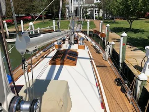 Light Reign Yacht Photos Pics Cherubini Schooner 2000 docked, showcasing wooden deck and rigging in a serene marina setting.