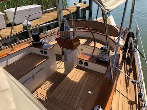 Light Reign Yacht Photos Pics Cherubini Schooner 2000 with wooden deck, docked at a marina, showcasing elegant craftsmanship.