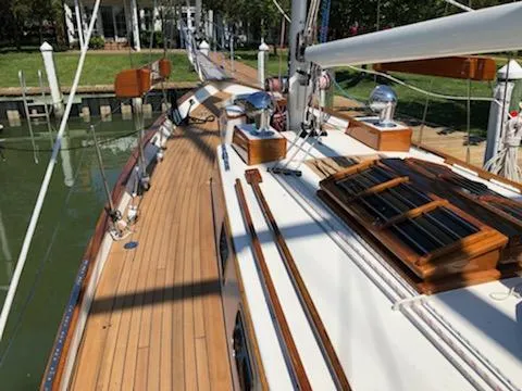 Light Reign Yacht Photos Pics Cherubini Schooner 2000 with wooden deck, docked at a marina.