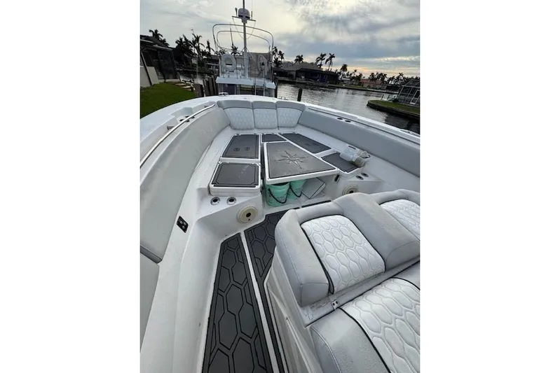  Yacht Photos Pics 2021 Sea Fox 368 Commander boat interior with cushioned seating and deck, docked by water.