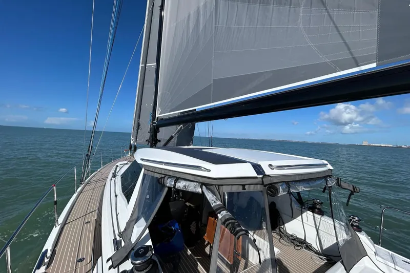  Yacht Photos Pics Modern 2025 Amel 50 sailboat cruising on open sea under clear blue sky.