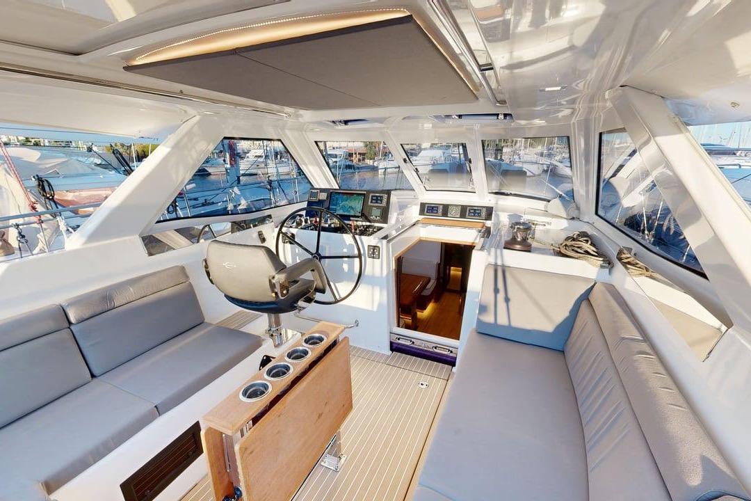 Luxurious interior of 2025 Amel 50 yacht with modern helm and seating area.