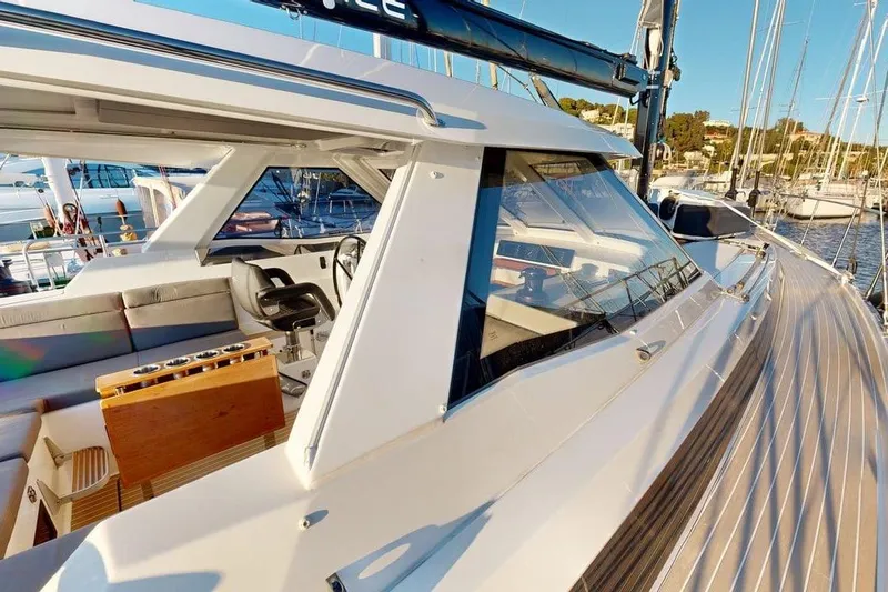  Yacht Photos Pics Modern 2025 Amel 50 yacht with sleek design and spacious deck in marina setting.