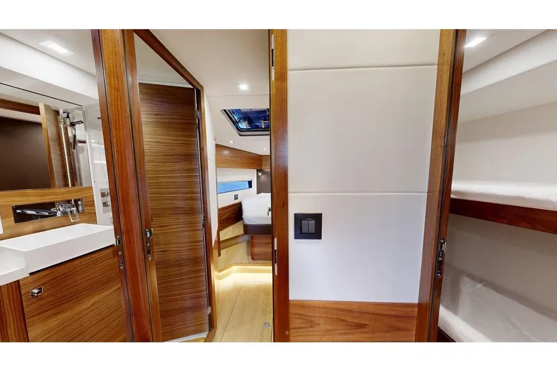  Yacht Photos Pics Luxurious interior of 2025 Amel 50 yacht featuring wood finishes and modern design.