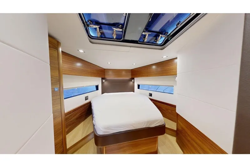  Yacht Photos Pics Luxurious cabin interior of 2025 Amel 50 yacht with wood accents and skylight.