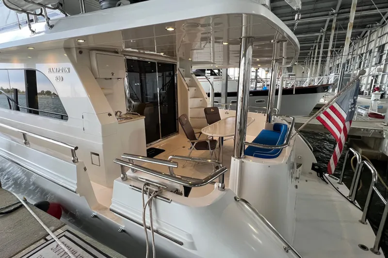 Bucephulas Yacht Photos Pics Luxurious 2012 Hampton motor yacht docked, featuring elegant outdoor seating and American flag.