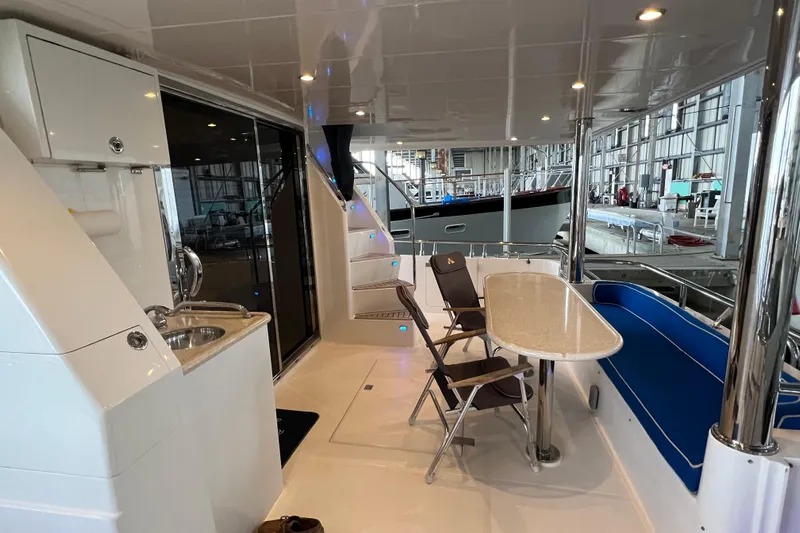 Bucephulas Yacht Photos Pics Luxurious 2012 Hampton motor yacht interior with seating, table, and kitchenette.