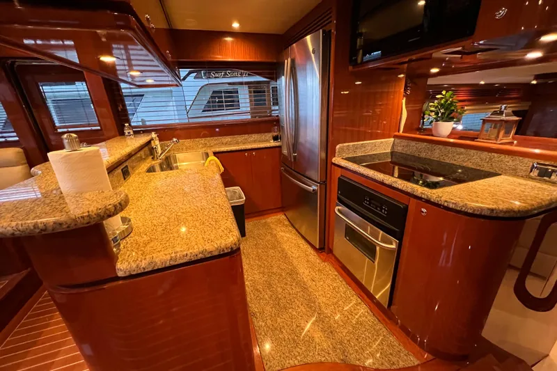 Bucephulas Yacht Photos Pics Luxurious kitchen interior of 2012 Hampton motor yacht with granite countertops and stainless steel appliances.