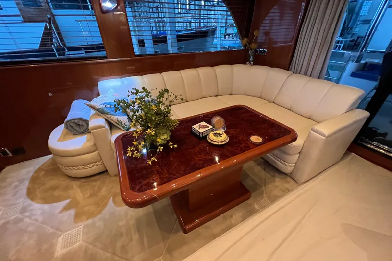 Bucephulas Yacht Photos Pics Luxurious 2012 Hampton motor yacht interior with elegant seating and wooden table.