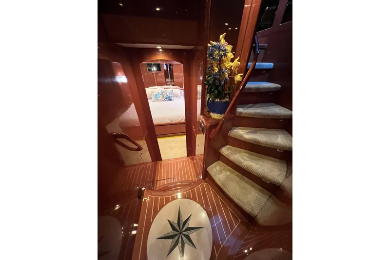Bucephulas Yacht Photos Pics Luxurious 2012 Hampton motor yacht interior with elegant staircase and floral arrangement.