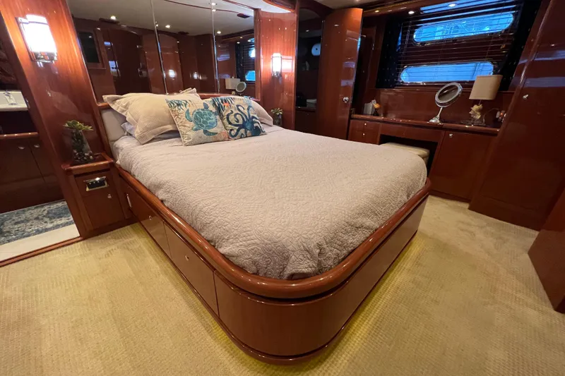 Bucephulas Yacht Photos Pics Luxurious bedroom interior of a 2012 Hampton motor yacht with elegant wood finishes.