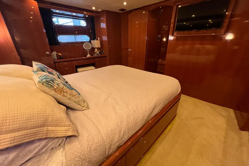 Bucephulas Yacht Photos Pics Luxurious bedroom interior of a 2012 Hampton motor yacht with elegant wood finishes.