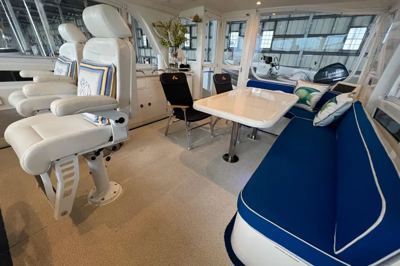 Bucephulas Yacht Photos Pics Luxurious 2012 Hampton motor yacht interior with white seating, blue cushions, and elegant dining area.