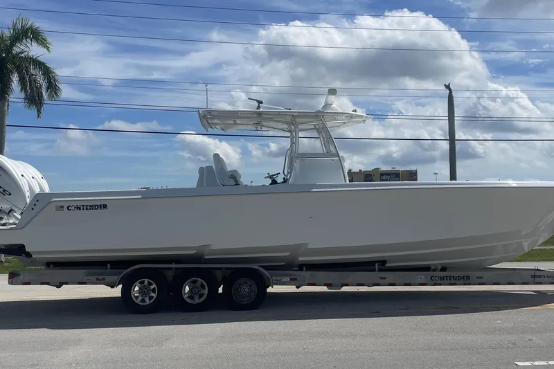  Yacht Photos Pics 2024 Contender 39 ST boat on trailer, parked under a clear blue sky.