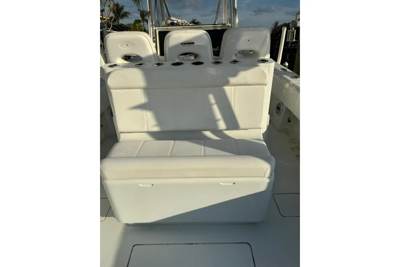  Yacht Photos Pics 2024 Contender 39 ST boat seating area with rod holders and white upholstery.