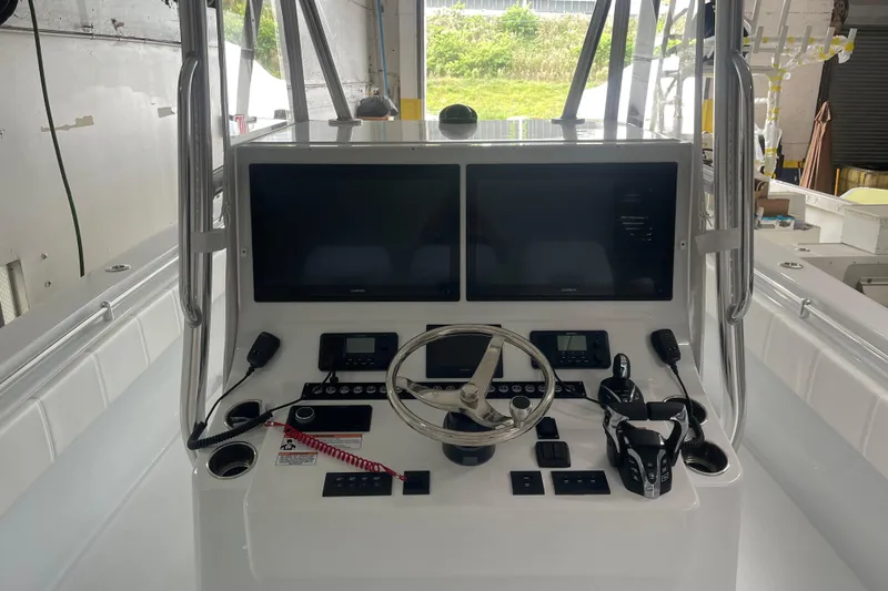  Yacht Photos Pics 2024 Contender 39 ST boat console with dual screens and steering wheel.