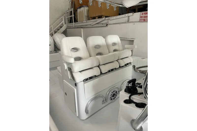  Yacht Photos Pics 2024 Contender 39 ST boat interior with white cushioned seating and control panel.