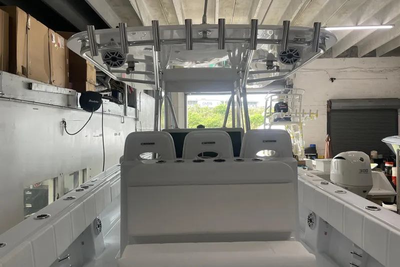  Yacht Photos Pics 2024 Contender 39 ST boat interior with seating and equipment in a garage setting.