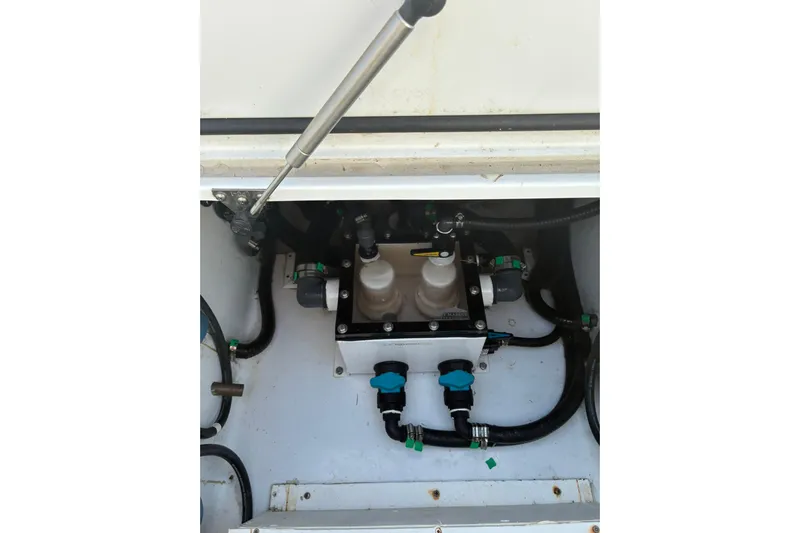  Yacht Photos Pics 2024 Contender 39 ST boat engine compartment with hydraulic components and hoses.