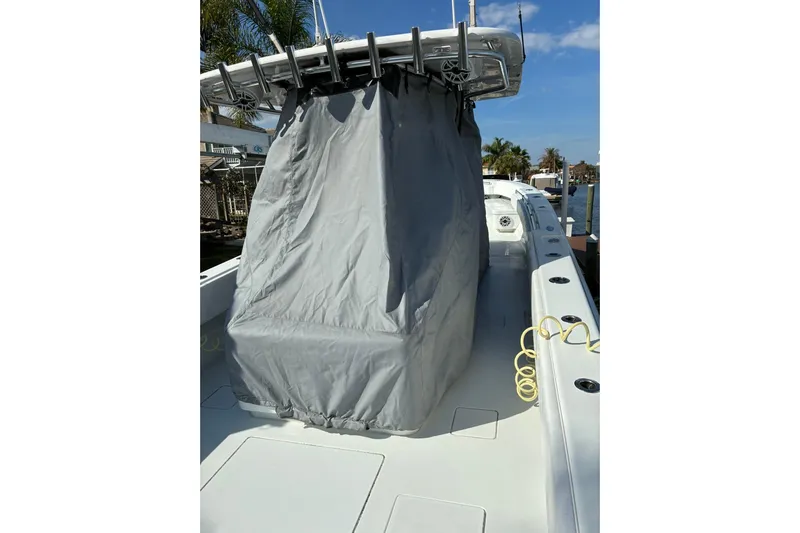  Yacht Photos Pics 2024 Contender 39 ST boat with covered console, docked under clear blue sky.