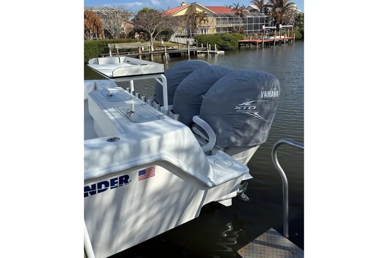  Yacht Photos Pics 2024 Contender 39 ST boat with Yamaha XTO outboard engines docked by waterfront.