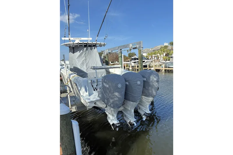  Yacht Photos Pics 2024 Contender 39 ST boat with triple Yamaha engines docked in marina.