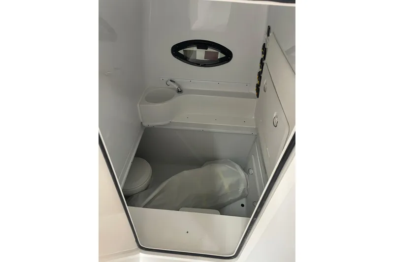  Yacht Photos Pics 2024 Contender 39 ST boat interior cabin with compact toilet and sink.