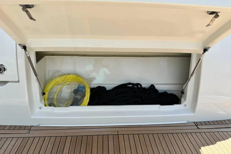  Yacht Photos Pics Storage compartment on 2026 Prestige F4.9 yacht with yellow cable and black rope.
