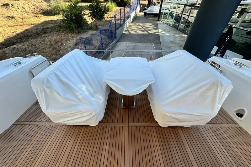  Yacht Photos Pics Prestige F4.9 yacht deck with covered seating and table, 2026 model.