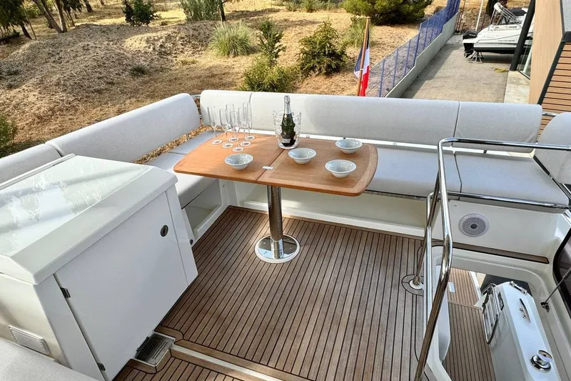  Yacht Photos Pics Luxurious 2026 Prestige F4.9 yacht deck with elegant seating and dining setup.