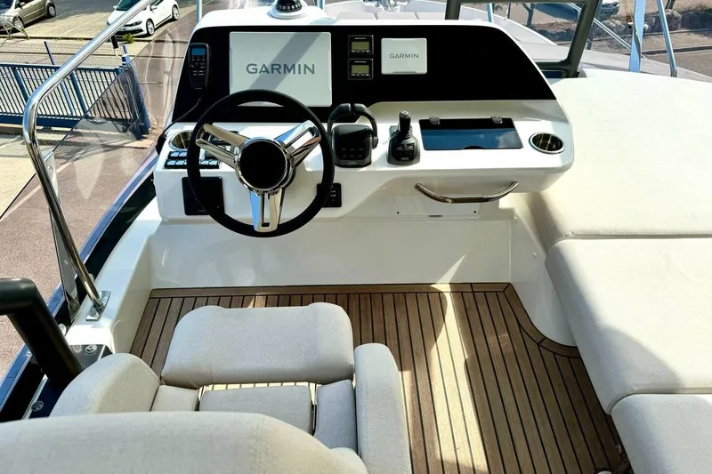  Yacht Photos Pics Modern helm of 2026 Prestige F4.9 yacht with Garmin navigation system.