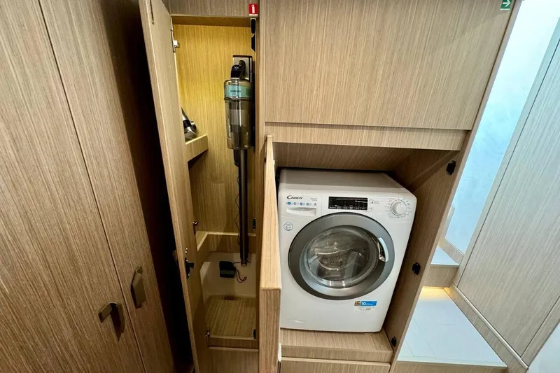  Yacht Photos Pics Laundry area with washing machine and storage in Prestige F4.9, 2026 model.