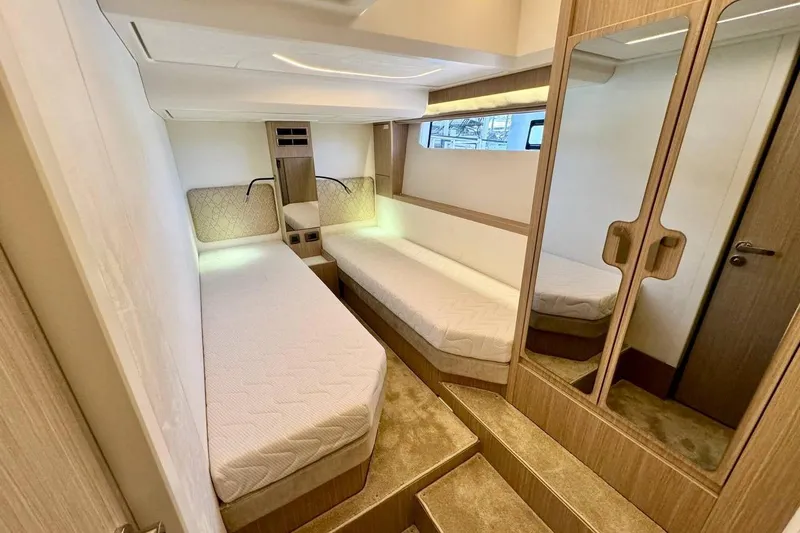  Yacht Photos Pics Luxurious cabin interior of 2026 Prestige F4.9 yacht with twin beds and mirrored wardrobe.