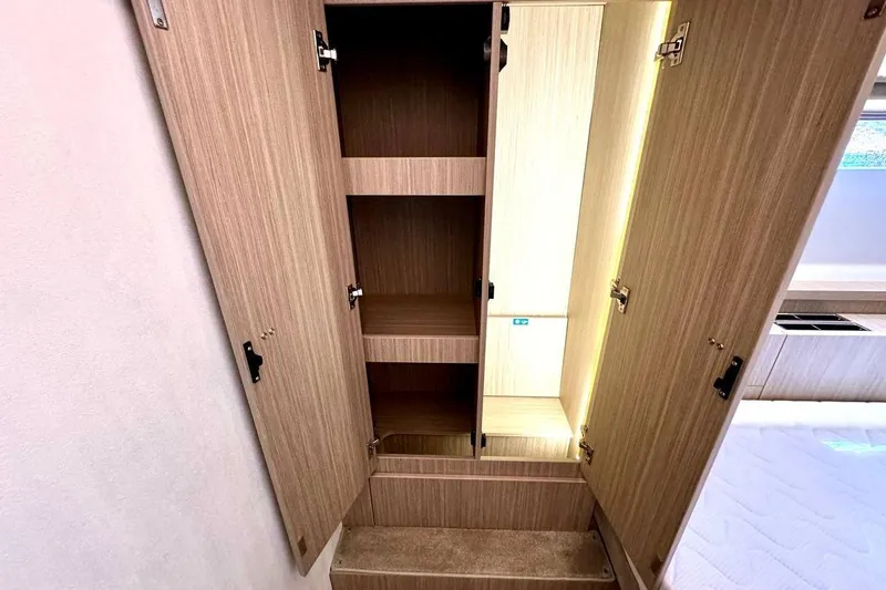  Yacht Photos Pics Open wooden cabinet with shelves in Prestige F4.9, 2026 model.