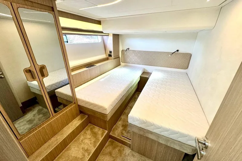  Yacht Photos Pics Luxurious cabin interior of 2026 Prestige F4.9 yacht with twin beds and elegant wood finish.