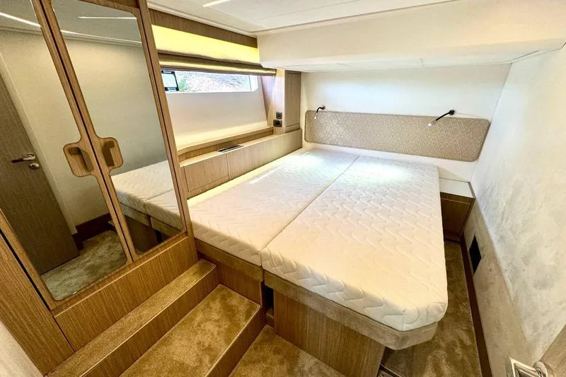  Yacht Photos Pics Luxurious cabin interior of 2026 Prestige F4.9 yacht with modern design and comfortable bedding.