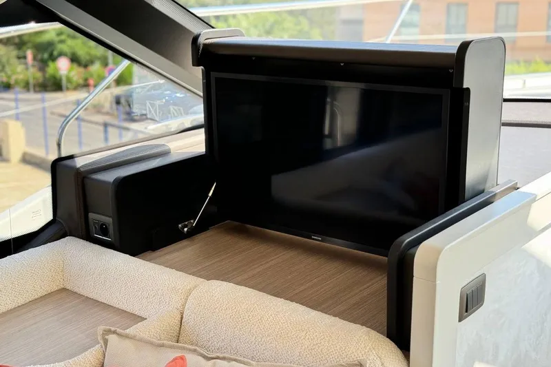  Yacht Photos Pics Luxurious interior of 2026 Prestige F4.9 yacht with retractable TV and plush seating.