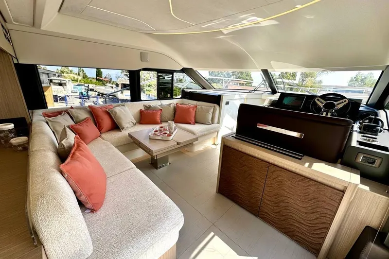  Yacht Photos Pics Luxurious 2026 Prestige F4.9 yacht interior with plush seating and modern helm.